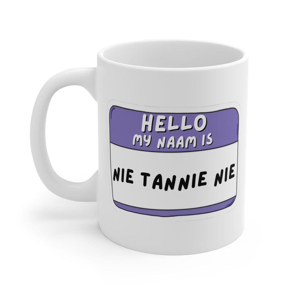 A white ceramic mug with a printed name-tag style graphic in purple and black text reading 'HELLO MY NAAM IS NIE TANNIE NIE' on a clean white background.